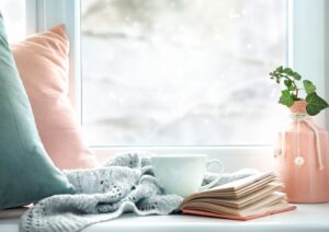pink-green-pillows-and-blanket-in-sunny-window-seat